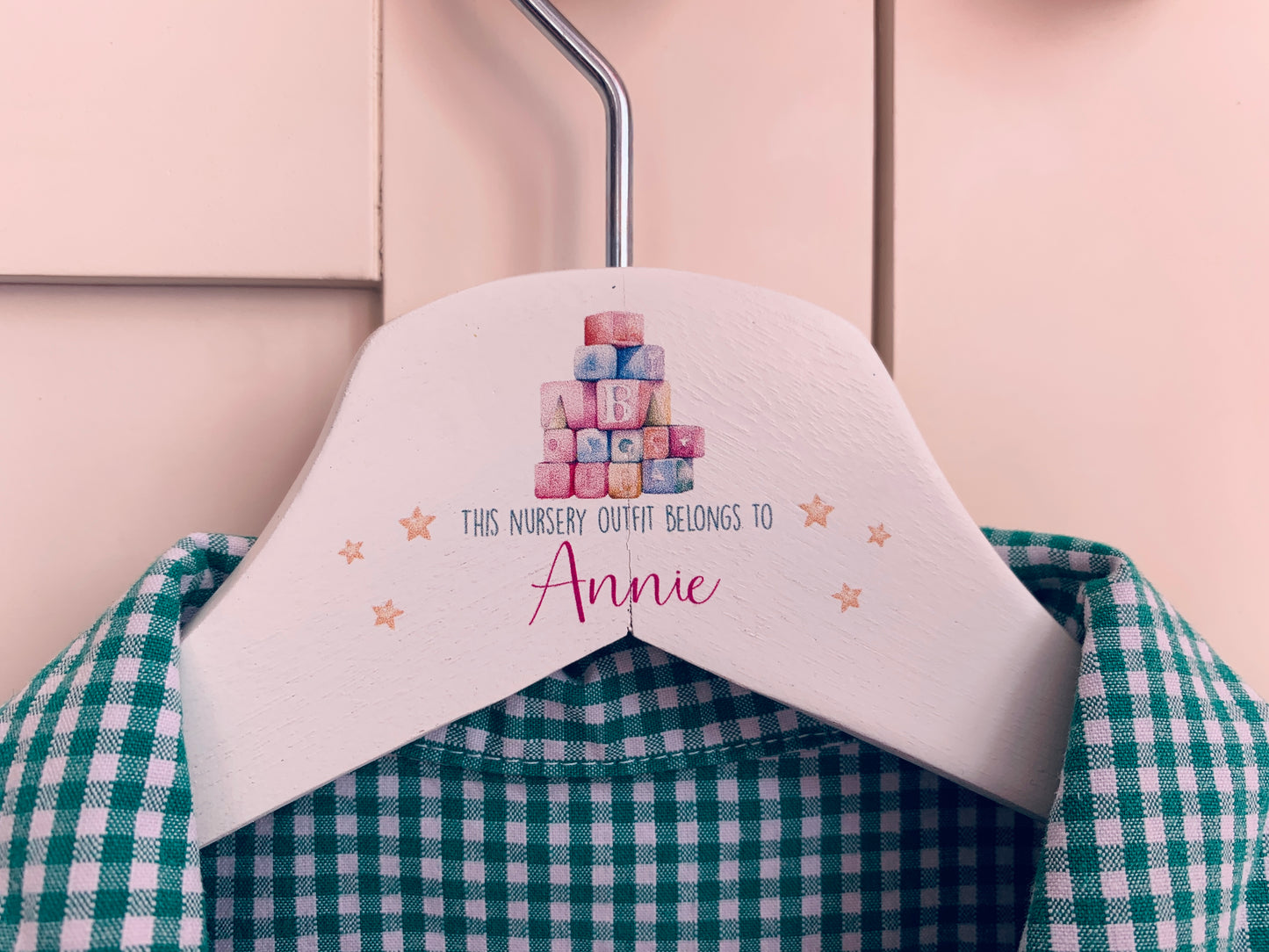 Nursery uniform hanger