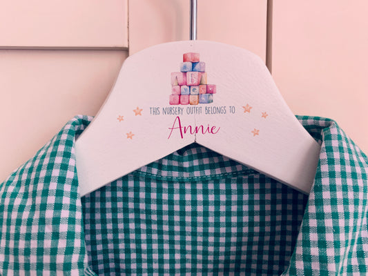 Nursery uniform hanger